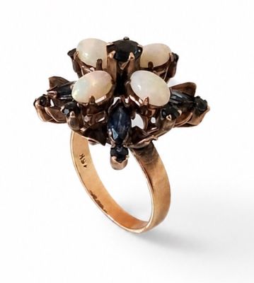 an image of a gold ring with oplites and sapphires