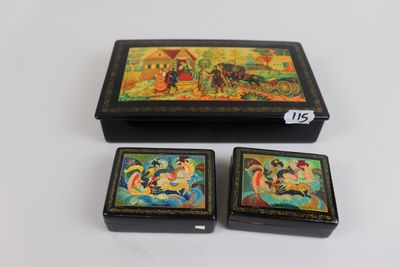 three small boxes with paintings on them sitting on a table