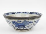 a blue and white bowl with a horse on it