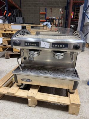 an image of a coffee machine sitting on top of a wooden pallet