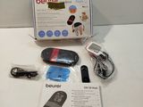 a box with a remote control and other items on a table