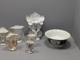 many different types of vases and bowls on the table