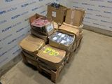 boxes of assorted items are stacked on a pallet in front of a wall