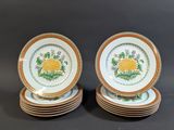 six plates with yellow and green designs are stacked on top of each other