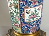 a blue vase with a gold handle on a stand
