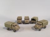 six toy army vehicles that are lined up on a table