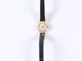 a close up of a watch on a white surface with a white background