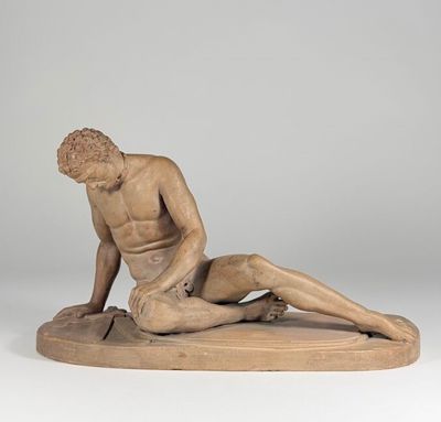 an image of a statue of a man laying on the ground