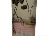 a glass vase with a picture of a tree branch on it