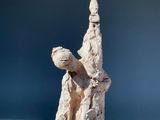 a small statue of a man holding a bird on his arm