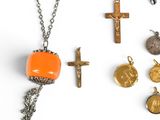 an image of a collection of religious items including a cross, a necklace, and a coin