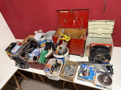 a lot of tools on a table with a red wall