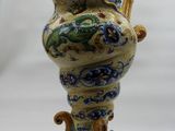 a blue and yellow vase with a dragon on it