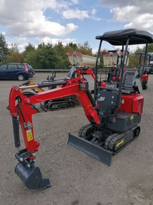 an image of a small red excavator parked in a parking lot