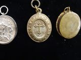 three gold and silver medals with a picture of jesus on them