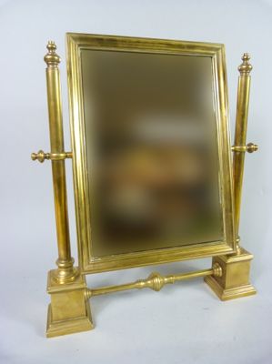 a mirror that is sitting on top of a stand