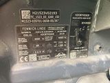 a close up of a car ' s engine label on the side of the car