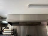 une cuisine équipée d'une cuisinière et d'une hotte aspirante