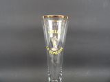 a clear glass with a gold rim on it