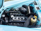 a blue car with an engine in it ' s trunk
