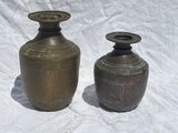 two vases that are sitting on a white surface