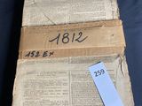 an old book that has a ruler on top of it
