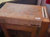 a wooden table with a knife on it in a kitchen