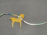 a toy horse that is connected to a ribbon