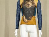 a mannequin with a lion on it in front of a curtain