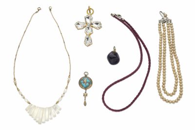 various necklaces and bracelets are displayed on a white surface