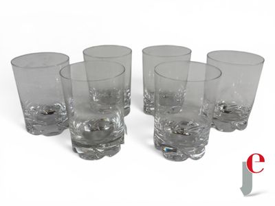 six glasses are lined up in a row on a white surface