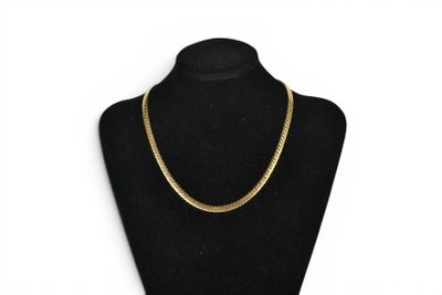 a black mannequin with a gold chain on it