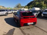 a red car that is parked in a parking lot