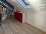 an image of a room with a red cabinet and a skylight