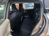 the back seats of a car with the door open in a parking lot