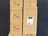 several cardboard boxes stacked on top of each other in front of a black wall