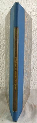 a blue book that is on a white surface