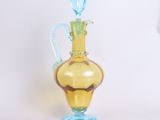 a yellow glass bottle with a blue handle on a white background