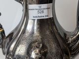 a silver tea pot with a label on it