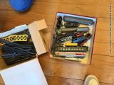 a box full of toy trains on a wooden floor