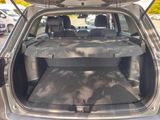 the back of a car with its trunk open and the seats folded down