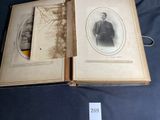 an old photo of a man in a suit and tie in an open book
