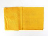 a close up of a yellow handkerchief on a white surface