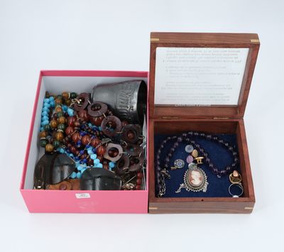 an open box with a bunch of jewelry inside of it