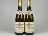two bottles of wine sitting next to each other on a table