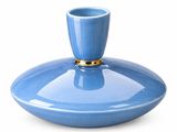 a blue vase with a gold rim sitting on a white surface