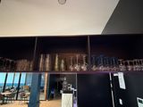 a shelf with wine glasses on top of it