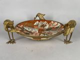 three birds that are sitting on a plate
