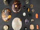 many different types of stones on a black surface