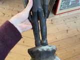 a person that is holding a statue in their hand